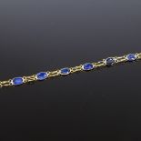 An unmarked gold oval-cut sapphire line bracelet, bracelet length 19cm, 2.3g Good original