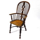 A 19th century bow-arm Windsor chair with crinoline stretcher