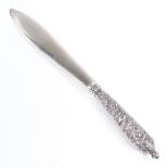 A Victorian Scottish silver paper knife, relief embossed floral handle with plain silver blade, by