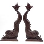 A pair of Victorian relief carved mahogany dolphin design brackets, height 67cm