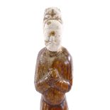 A Chinese Han dynasty treacle glaze pottery standing figure, height 20cm Minor glaze chips