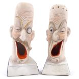 A pair of early 20th century French porcelain novelty caricature design cigarette holders, height