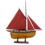 A Victorian wooden hulled model pond yacht, with sails and rigging, hull length 72cm, on wood stand,