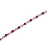 An 18ct white gold ruby and diamond cluster panel line bracelet, maker's marks P and S, hallmarks