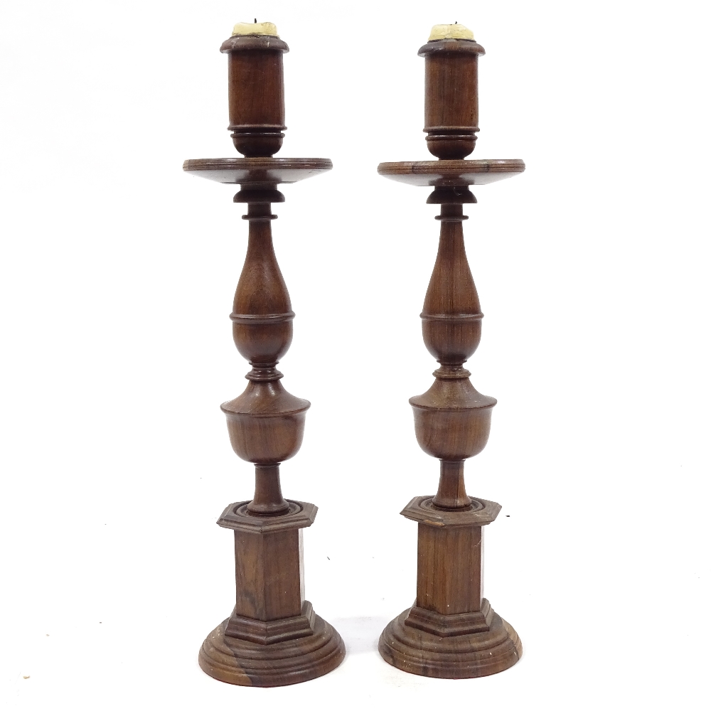 A pair of 19th century rosewood candle holders, height 39cm