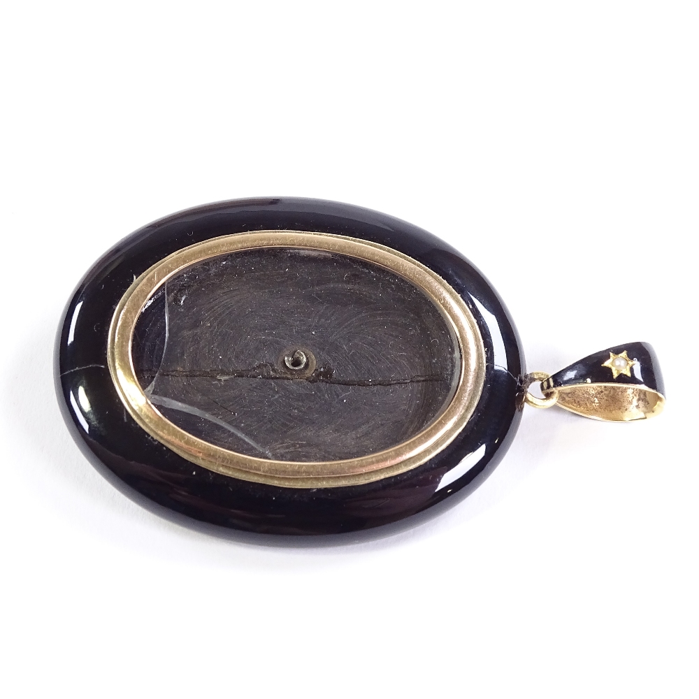 A Victorian unmarked gold black enamel split-pearl and onyx locket memorial pendant, with vacant - Image 3 of 4