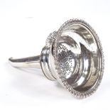 A George III silver 2-section wine funnel, gadrooned border with pierced strainer, shell clip and