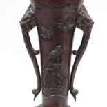 A Japanese relief cast bronze 2-handled vase, with raised bird decorated panels on stand, overall