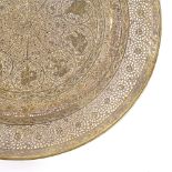 An ornate Middle Eastern brass plate, with pierced and engraved decoration, diameter 23cm