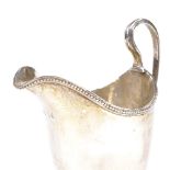 A George III silver helmet shape cream jug, beaded lip on stepped base, maker's marks IB,