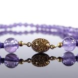 A polished amethyst bead necklace, with silver-gilt clasp, necklace length 70c, 84.7g Very good