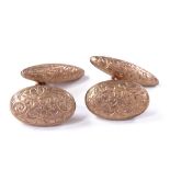 A pair of 9ct rose gold bombe cufflinks, floral engraved panels, hallmarks Birmingham 1907, oval
