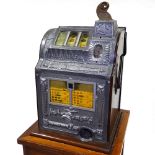 An American Bell Fruit coin-in-the-slot fruit machine, circa 1930, mahogany and cast-aluminium case,