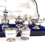 An Edwardian 7-piece silver cruet set, pedestal urn and baluster form, by William Comyns & Sons,