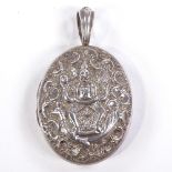 An Indian unmarked silver oval photo locket pendant, depicting incarnation of Ganesha riding a
