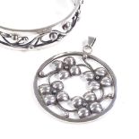 A Jorgen Kjaer Poulsen Danish sterling silver hinged bangle, and a Poulsen silver pendant, floral