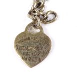 A silver-gilt graduated curb-link Albert chain, with Tiffany & Co Return heart tag, dog clip and T-