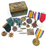 A tin containing badges and medals, including 3 First War medals to the Scottish Rifles