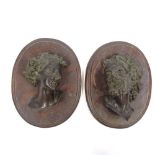 A pair of patinated bronze Classical heads, circa 1900, unsigned, mounted on oak plaques, height