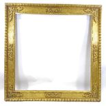 A large 19th century relief carved giltwood mirror frame, 1.75m x 1.75m