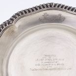 A late Victorian circular silver dinner plate, gadrooned scalloped rim with engraved emblem border,