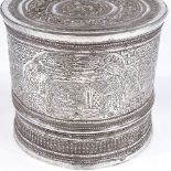 A large Shan Burmese unmarked silver Betel nut box, relief embossed floral lid with engraved village