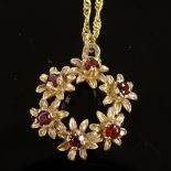 A 9ct gold garnet floral pendant necklace, on 9ct rope twist chain, pendant diameter 18.8mm, chain