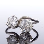 An unmarked white gold 2-stone diamond crossover ring, total diamond content approx 2.5ct, larger