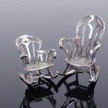 A pair of miniature sterling silver rocking chairs, by Phillips of England, dated 1991, largest