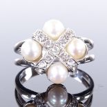 A 14ct white gold whole-pearl and white sapphire cross ring, openwork shoulders, setting height 15.
