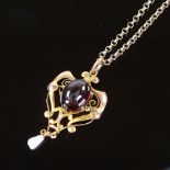 An Art Nouveau unmarked gold high cabochon rubellite tourmaline and blister pearl pendant