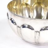 A large German silver circular fruit bowl, ribbon and reed relief embossed decoration with gilt
