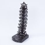 A wrought-iron 7-section tiered letter rack on veined black marble plinth, marked Hanau, overall