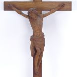 A carved and stained oak crucifix, height 56cm