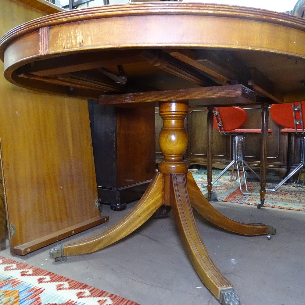 A reproduction mahogany bow-end pull-out dining/boardroom table, having tooled black leather - Image 2 of 3