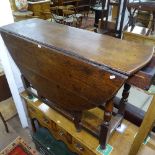 An Antique oak oval gateleg table, with end frieze drawer, raised on turned legs