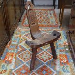 A rustic polished pine spinning stool