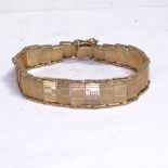 A 9ct gold engraved and articulated panel bracelet, length 16.5cm, 12.3g