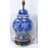 An Oriental blue and white ceramic table lamp on wooden plinth, height 42cm overall