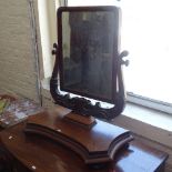 A Regency mahogany dressing table swing mirror, on a serpentine-shaped base, W75cm, H78cm