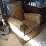 An early 20th century brown leather-upholstered Club chair