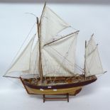 A scratch-built wooden hull model boat, with sails and rigging, overall height 80cm