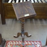 An Arts & Crafts oak music stand, the panel carved with LAS, H90cm