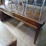 A French stained pine plank-top farmhouse table, with sliding frieze door, raised on square