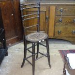 An early 20th century cane-seated correction chair