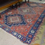 An Antique red ground Afghan rug, 205cm x 135cm