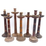Various turned wood copper-bound table candlesticks, largest height 44cm (7)