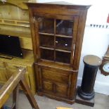 A Titchmarsh and Goodwin oak design corner cupboard, with lattice glazed and fielded panelled