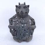 A verdigris Mr Badger candleholder, with pierced body and hinged back, height 33cm