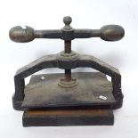 A large Victorian cast-iron book press, with brass-mounted rotating handles, base length 42cm